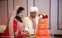 Indian bride and groom cutting the cake Indian bride and groom cutting the cake