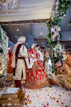 Lovely Indian bride climbing over a stone. Lovely Indian bride climbing over a stone.
