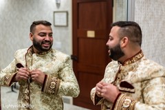 Charming Indian groom putting his ceremony outfit. Charming Indian groom putting his ceremony outfit.