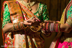Indian bride putting her Hathphool on. Indian bride putting her Hathphool on.