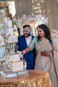 Sweet moment of Indian bride and groom cutting cake. Sweet moment of Indian bride and groom cutting cake.