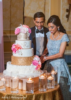 Cheerful Indian bride and groom cutting the cake. Cheerful Indian bride and groom cutting the cake.