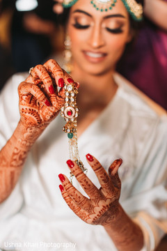 Indian bride putting her Hathphool on. Indian bride putting her Hathphool on.