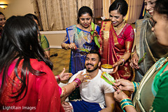 Indian wedding ritual of painting the groom with yellow turmeric paste Indian wedding ritual of painting the groom with yellow turmeric paste