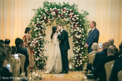 Joyful Indian couple kissing at ceremony. Joyful Indian couple kissing at ceremony.