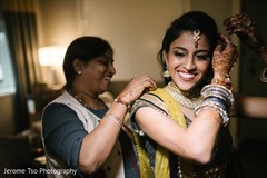 Indian bride being assisted Indian bride being assisted