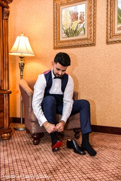 Elegant Indian groom putting his reception shoes. Elegant Indian groom putting his reception shoes.