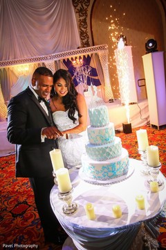 Lovely Indian lovebirds cutting cake together. Lovely Indian lovebirds cutting cake together.