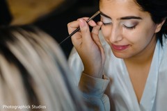 Lovely Indian bride getting her makeup done. Lovely Indian bride getting her makeup done.