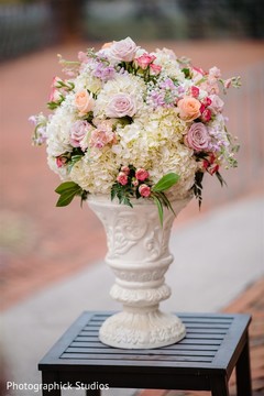 Elegant Indian wedding flowers with white flowers vase. Elegant Indian wedding flowers with white flowers vase.