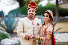 Indian groom and bride posing for pictures Indian groom and bride posing for pictures