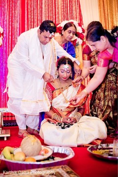 Indian groom offers bride protection with the sacred necklace. Indian groom offers bride protection with the sacred necklace.