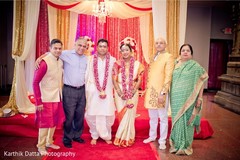 Lovely Indian couple posing with relatives at mandap. Lovely Indian couple posing with relatives at mandap.