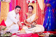 Charming Indian groom putting offerings to sacred coconut. Charming Indian groom putting offerings to sacred coconut.