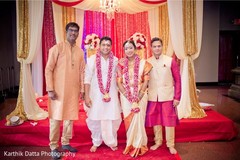 Enchanting Indian couple posing with relatives. Enchanting Indian couple posing with relatives.
