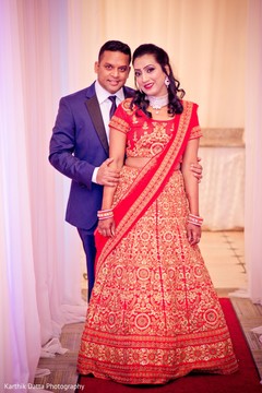 Lovely Indian couple posing at reception entrance. Lovely Indian couple posing at reception entrance.
