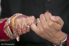 Enchanting indian couple showing wedding rings Enchanting indian couple showing wedding rings