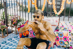 Indian groom is smeared in yellow turmeric paste Indian groom is smeared in yellow turmeric paste