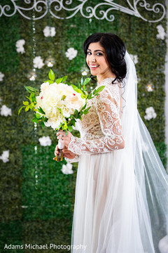 Adorable indian bride showing her amazing bouquet Adorable indian bride showing her amazing bouquet