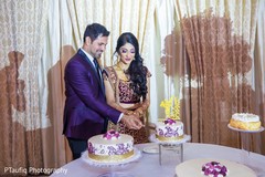 Sweet Indian couple cutting their wedding cake. Sweet Indian couple cutting their wedding cake.