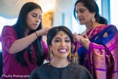Enchanting Indian bride getting her hair done. Enchanting Indian bride getting her hair done.