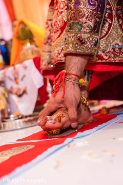 Indian couple when stepping on nuts with toes ritual. Indian couple when stepping on nuts with toes ritual.