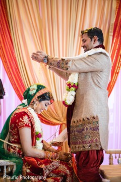 Indian groom pouring rice on to bride's head. Indian groom pouring rice on to bride's head.