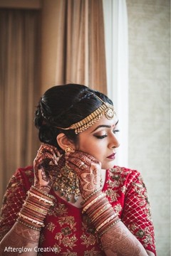 Indian bride putting her ceremony jewelry on. Indian bride putting her ceremony jewelry on.