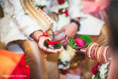 Indian couple holding areca nut , flower petal and rice on leaf. Indian couple holding areca nut , flower petal and rice on leaf.