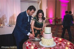 Cheerful Indian bride and groom cutting the cake. Cheerful Indian bride and groom cutting the cake.