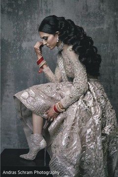 Glamorous Indian bride posing on her reception outfit. Glamorous Indian bride posing on her reception outfit.