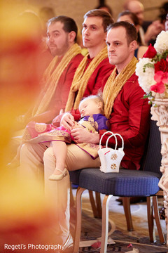 Indian groomsmen holding sweet sleeping baby. Indian groomsmen holding sweet sleeping baby.