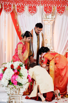 Indian couple completing the ceremony with the bride's parents. Indian couple completing the ceremony with the bride's parents.