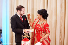Indian bride giving the groom a taste of wedding cake. Indian bride giving the groom a taste of wedding cake.