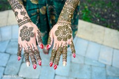 Beautiful indian bride showing henna art. Beautiful indian bride showing henna art.