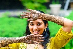 Beautiful indian bride showing henna art. Beautiful indian bride showing henna art.