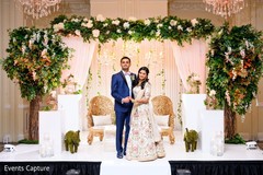 Lovely Indian couple posing at their wedding reception stage. Lovely Indian couple posing at their wedding reception stage.