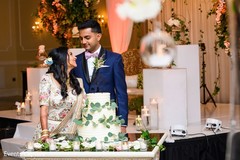 Indian couple posing with wedding cake. Indian couple posing with wedding cake.