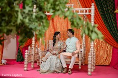 Lovely Indian couple seating at their sangeet swing seat. Lovely Indian couple seating at their sangeet swing seat.