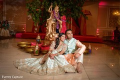 Indian couple posing with Indian gods at sangeet. Indian couple posing with Indian gods at sangeet.