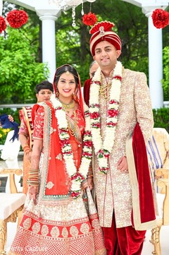 Indian bride and groom at their varmala garland exchange ritual. Indian bride and groom at their varmala garland exchange ritual.