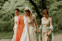 Beautiful Indian bride being assisted by her bridesmaids. Beautiful Indian bride being assisted by her bridesmaids.