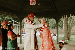 Indian groom exchanging garland with his lovely bride. Indian groom exchanging garland with his lovely bride.