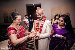 Indian groom receiving flowers from his next mother in law. Indian groom receiving flowers from his next mother in law.