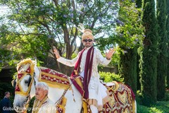 Joyful Indian groom riding a majestic horse in baraat. Joyful Indian groom riding a majestic horse in baraat.