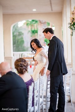 Indian couple seating at their wedding reception table. Indian couple seating at their wedding reception table.