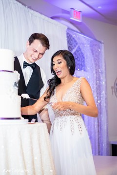 Fun capture of Indian bride and groom cutting cake. Fun capture of Indian bride and groom cutting cake.