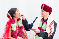 Lovely Indian groom giving food to bride during wedding ceremony. Lovely Indian groom giving food to bride during wedding ceremony.