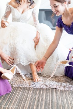 Indian bride getting her wedding shoes on. Indian bride getting her wedding shoes on.