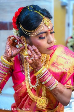 Indian bride putting earrings on Indian bride putting earrings on
